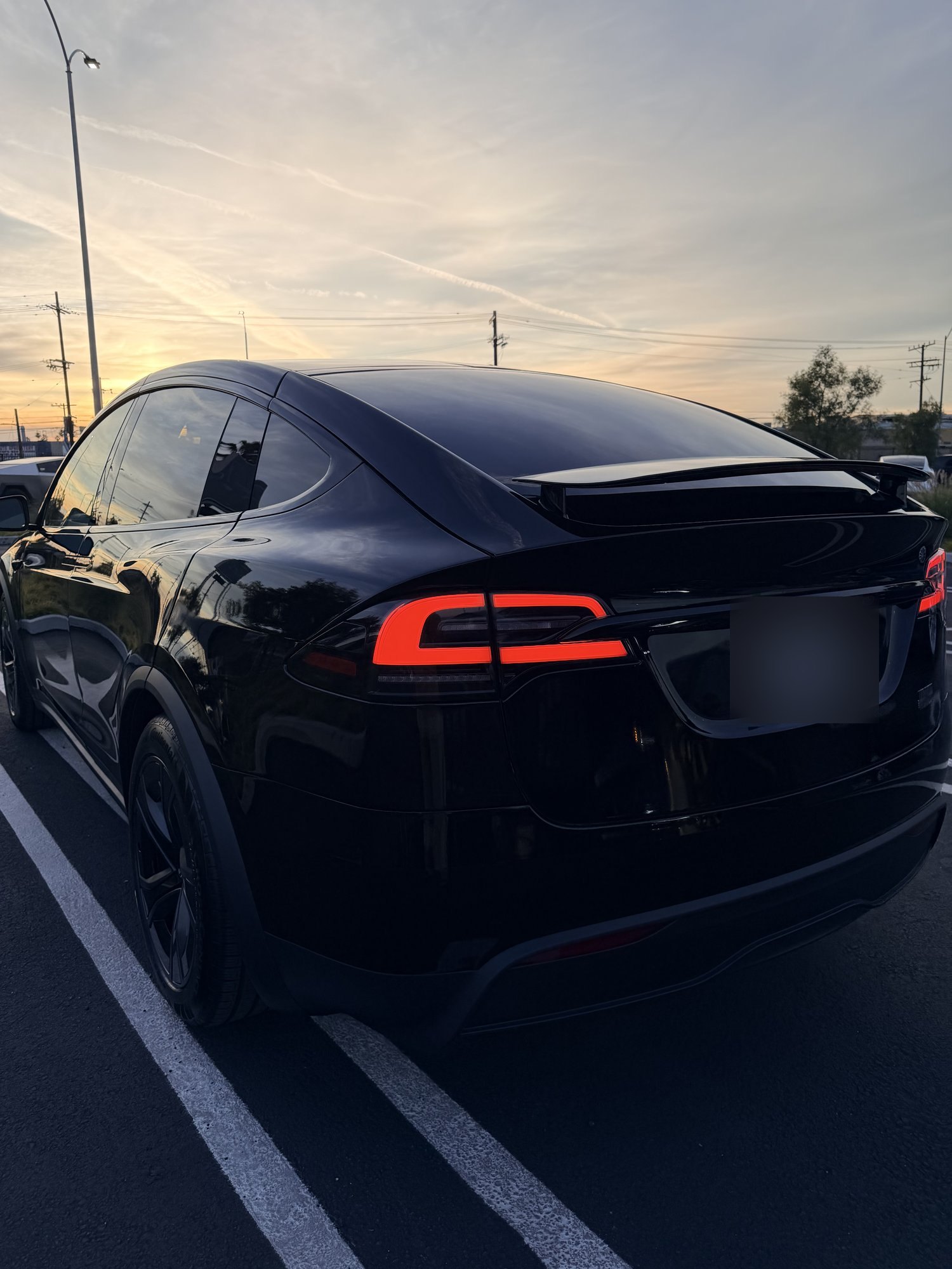 TESLOVE 2026 Tesla Model X Plaid in Diamond Black, rear three-quarter at dusk